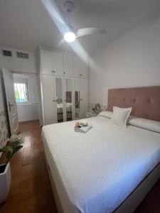 a bedroom with a large white bed with a ceiling fan at Cortijo Indalo in Pechina