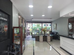 a lobby of a store with a person sitting in a chair at Mindú Park Hotel in Manaus
