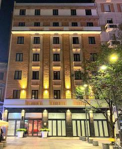 a large brick building with windows and doors at night at BB Hotels Smarthotel Duomo in Milan