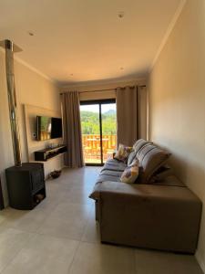 a large living room with a couch and a television at Casa na Serra Gaúcha in Igrejinha