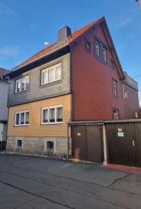 a large red brick house with a garage at Ferienwohnung Mack 1 in Wernigerode +6 photos