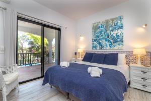 um quarto com uma cama grande e uma varanda em Casa Palmeiras Luxury Tranquil area BBQ Large Pool em Carvoeiro