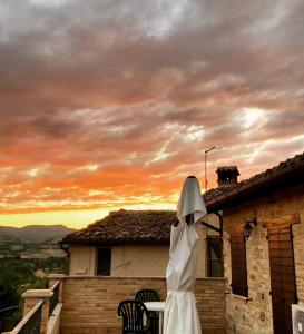 a nun standing on the roof of a house at Agriturismo L'Antico Oliveto in San Severino Marche