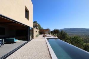 an external view of a house with a swimming pool at Villa Terra Motovun in Motovun