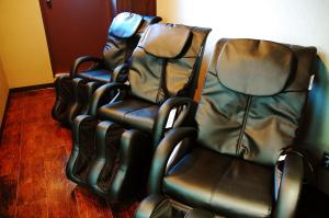 a row of empty chairs in a room at Anshin Oyado Ginza Shimbashi Station - For Men in Tokyo