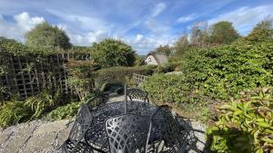 a table and chairs sitting on a patio at The Nook - Charming cottage, modern living with original features, perfect private garden in Dittisham