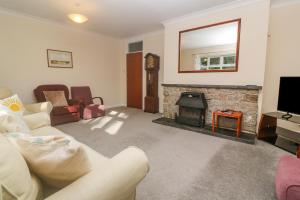a living room with a couch and a fireplace at Yngywidden in Penzance