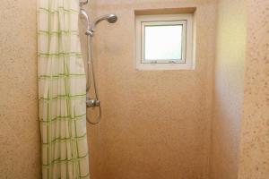 a shower in a bathroom with a window at Yngywidden in Penzance +20 photos
