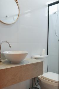 a bathroom with a sink and a toilet at Casa de Praia Areia Vermelha in Cabedelo