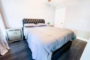 a bedroom with a large bed with a brown headboard at The Haines Villa in Niagara Falls