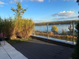 a deck with a view of a body of water at Apartament Winnica in Toruń