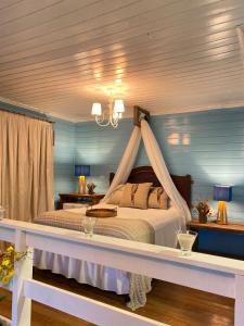 1 dormitorio con 1 cama con dosel en Reserva da Collina en Gramado