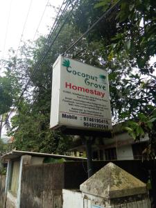 a sign for a house with a sign for at Coconut Grove in Cochin