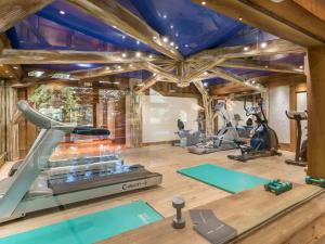 a gym with a treadmill and exercise equipment at Appartement Méribel, 3 pièces, 4 personnes - FR-1-566-37 in Les Allues