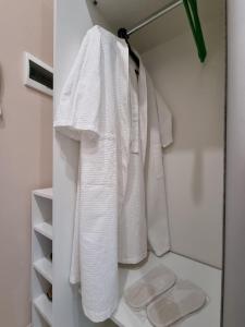 a bathroom with white towels hanging on a rack at 1 комнатная рядом c EXPO, Mega Silk Way in Astana