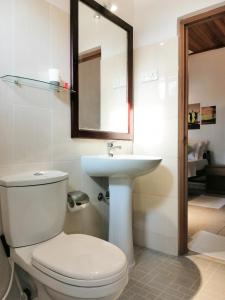 a bathroom with a white toilet and a sink at Villa One64 Beach Front - Apartments in Hikkaduwa