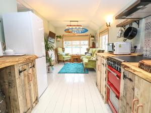 a kitchen with wooden cabinets and a stove at The Shack in Norwich