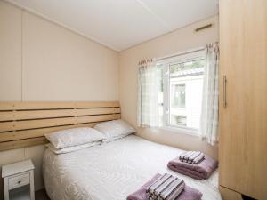 a small bedroom with a bed and a window at 3 Old Orchard in Much Wenlock