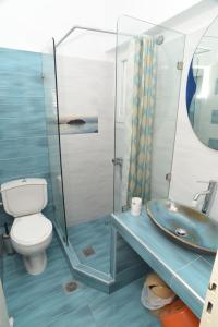 a bathroom with a toilet and a sink at Studios Kahlua in Agios Prokopios