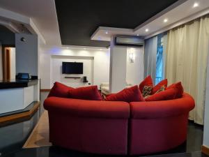 a living room with a red couch in a room at Relax at Heliopolis in Cairo
