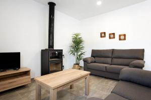 a living room with a couch and a coffee table at Villa Montenmedio - Juande in El Soto
