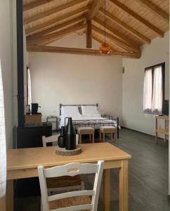a room with a table and a bed in the background at Agriturismo Pizzavacca in Villanova sullʼArda