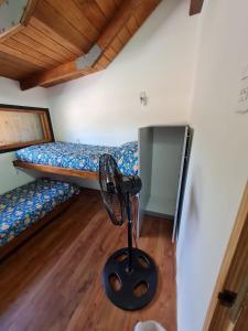 a room with two bunk beds and a fan at La casa de Hostal del Sol in Rosario