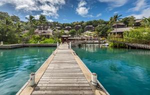 a wooden bridge over the water at a resort at Zoetry Marigot Bay - All Inclusive in Marigot Bay