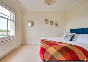 a bedroom with a bed and a window at Forest Lodge in Southwold