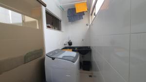 a small bathroom with a toilet and a sink at Recanto do Mundaí - Apto 201 in Porto Seguro