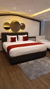 a bedroom with a large bed with red pillows at Luxury Villa Belvedere Bali in Seminiak in Legian