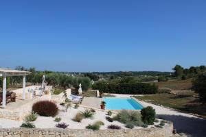 an external view of a villa with a swimming pool at Trullo Davide in Martina Franca