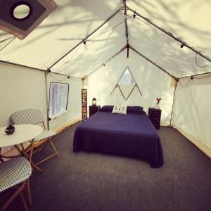 a bedroom with a bed in a tent at Tentrr Signature Site - Hunkerdown Hollow in Sevierville