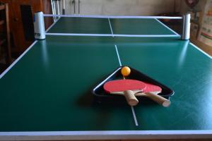 a ping pong racket and ball on a pool table at Eureka! in Winterton