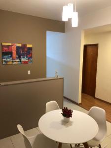 a white table and chairs in a room at Pousada HD in Nova Friburgo