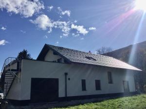a white building with a roof on top of it at Murperle in Sankt Michael im Lungau