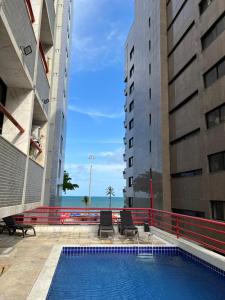 a view of a pool between two buildings at Flat - Navegantes Residence Hotel in Recife