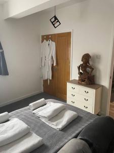 a bedroom with a bed with towels and a dresser at Terry’s yard, southville, Bristol in Bristol