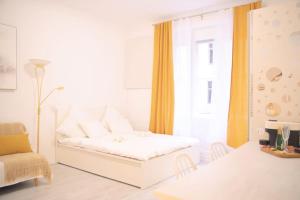 a white bedroom with a bed and a window at Room 4 Art Appartments Nr.2 in Wien Zentrum in Vienna