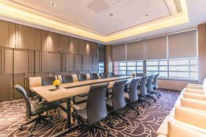 a conference room with a long table and chairs at Somerset Grandview Shenzhen in Shenzhen