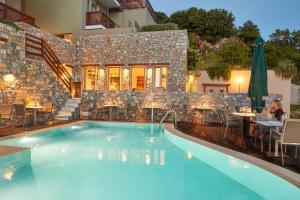 a swimming pool in front of a house at Mystery Skiathos Luxury Residence in Skiathos