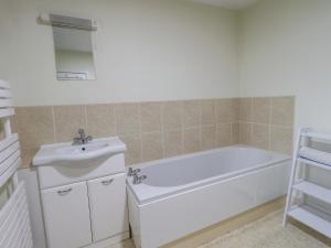 a bathroom with a white tub and a sink at Park Cottage in Ambleside +21 photos