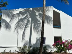 a mural of palm trees on the side of a building at OceanBlue Resort in Christ Church