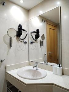 un baño con lavabo y espejo en Apartamento amplio, luminoso y confortable CC, en Madrid