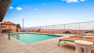 a swimming pool with tables and chairs in a building at Best Western View of Lake Powell Hotel in Page