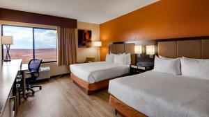 a hotel room with a large bed and a large window at Best Western View of Lake Powell Hotel in Page