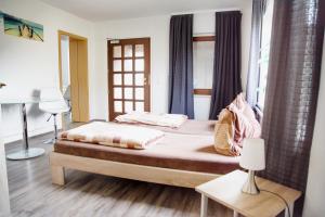 MönkebudeにあるHaff Ostseeferienhaus unteres Apartmentのベッドルーム1室(ベッド1台、テーブル、窓付)