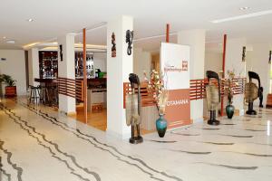 a lobby with vases on display in a store at Hôtel Printemps Mont Korhogo in Korhogo