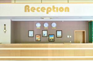 a reception area of an airport with clocks on the wall at Palma Hotel in Golden Sands