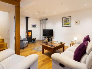 uma sala de estar com dois sofás e uma televisão em Willow Tree Barn em Kendal